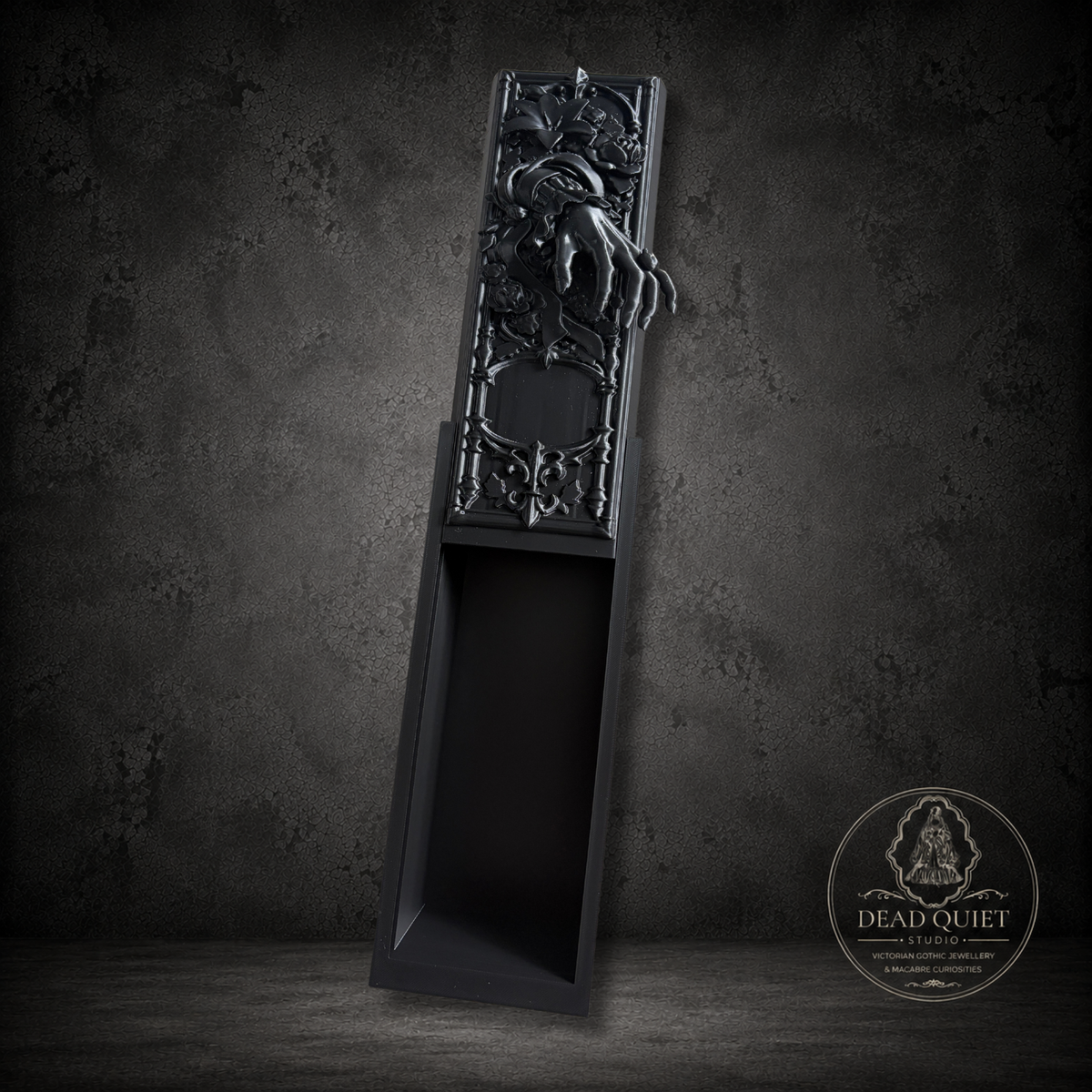 Victorian mourning book nook showing detailed black floral relief and storage compartment